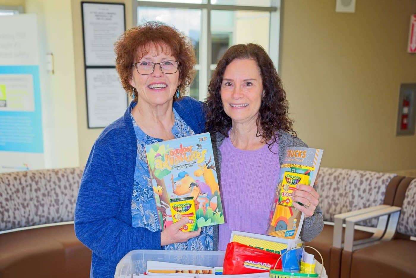 Debbie Cordero and Sharon Carvalho hold Alli's Inspiration coloring books.